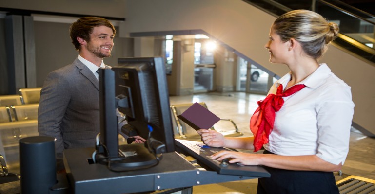 businessman-interacting-with-female-airport-staff-check-desk (1) businessman-interacting-with-female-airport-staff-check-desk (1)